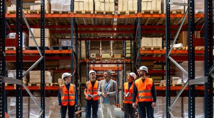 Logistics manager explaining and delegating operations to warehouse workers. Solve SMB Capacity Challenges