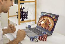 Discovering the Next Era of Digital Interactive Play at GameZone Casino Happy, excited man sitting at table with poker chips and looking at casino wheel on screen on GameZone Casino app