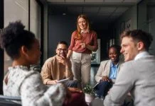 Why Engagement Scores are Failing Leaders A group of motivated professionals sharing ideas, laughter, engagement, collaboration and collaboration in a bright office space, reflecting teamwork and creativity in a business environment.