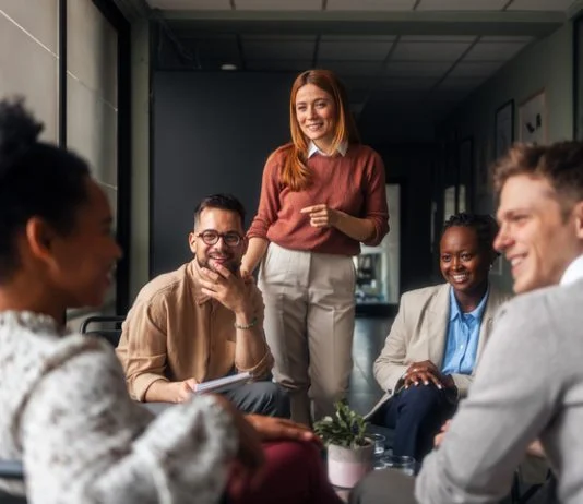 Why Engagement Scores are Failing Leaders A group of motivated professionals sharing ideas, laughter, engagement, collaboration and collaboration in a bright office space, reflecting teamwork and creativity in a business environment.