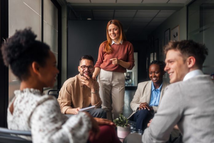 Group of Diverse Professionals Discussing Ideas in a Modern Office Setting A group of motivated professionals sharing ideas, laughter, engagement, collaboration and collaboration in a bright office space, reflecting teamwork and creativity in a business environment.