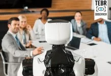 selective focus of multicultural businesspeople looking at AI robot in conference hall