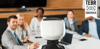 selective focus of multicultural businesspeople looking at AI robot in conference hall