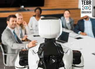 selective focus of multicultural businesspeople looking at AI robot in conference hall