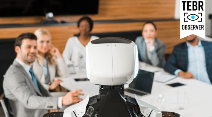 selective focus of multicultural businesspeople looking at AI robot in conference hall