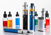 Modern electronic cigarettes, tobacco and bottles with assorted vape liquid on white background