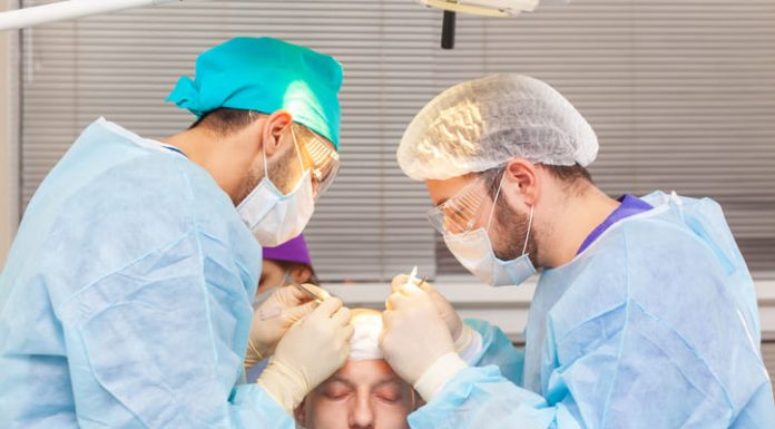 Baldness treatment. Hair transplant. Surgeons in the operating room carry out hair transplant surgery.