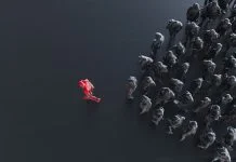 From Bottlenecks to Breakthroughs: The Business Case for Trust in Capability® Group of colored businessman with one red leader.Trust in capability concept