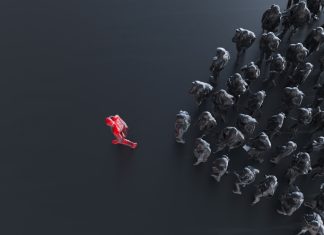 From Bottlenecks to Breakthroughs: The Business Case for Trust in Capability® Group of colored businessman with one red leader.Trust in capability concept