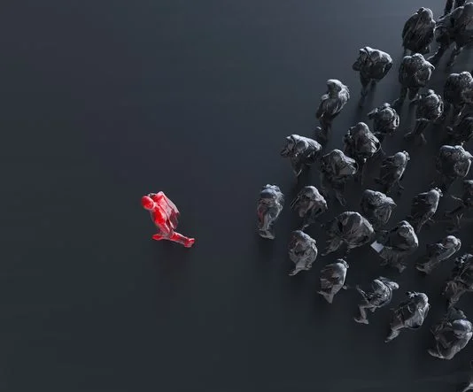 From Bottlenecks to Breakthroughs: The Business Case for Trust in Capability® Group of colored businessman with one red leader.Trust in capability concept