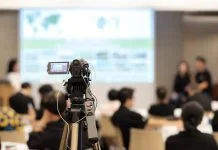 Video camera recording in seminar room during media training