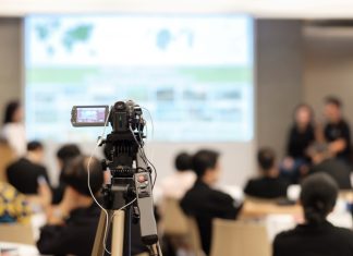 Video camera recording in seminar room during media training