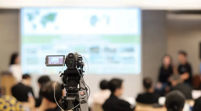 Video camera recording in seminar room during media training