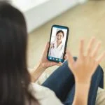 How Video Chat Is Reshaping Online Interaction Two women communicating through a video chat on their smartphones, engaging in a real-time online conversation