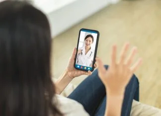 Two women communicating through a video chat on their smartphones, engaging in a real-time online conversation
