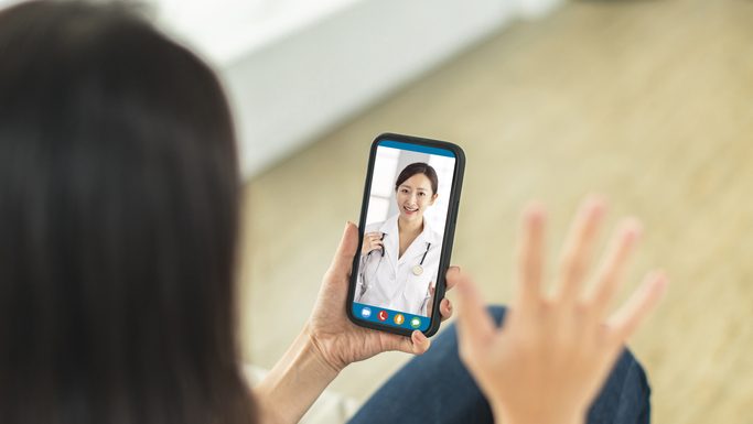Two women communicating through a video chat on their smartphones, engaging in a real-time online conversation