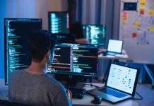 Software Development team working about coding promgram with software computer at night in office.