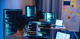 Software Development team working about coding promgram with software computer at night in office.