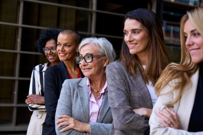 woman leaders, Graceful, smiling empowered diverse standing with arms crossed outdoor.