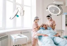 Professional trichologist surgeons carry out hair FUE Sapphire method hair transplant surgery in operating room to male patient with hair loss problem.