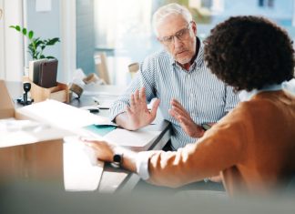 Here’s How to Have the Difficult Conversations at Work two employees having Conversations at Work