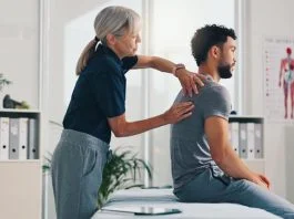 Person, physical therapy on injury for rehabilitation or recovery of muscle damage in clinic. UK Musculoskeletal