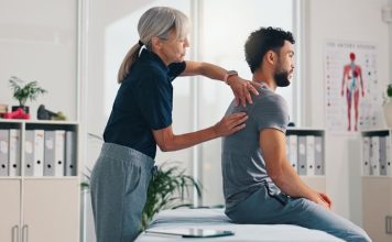 Person, physical therapy on injury for rehabilitation or recovery of muscle damage in clinic. UK Musculoskeletal