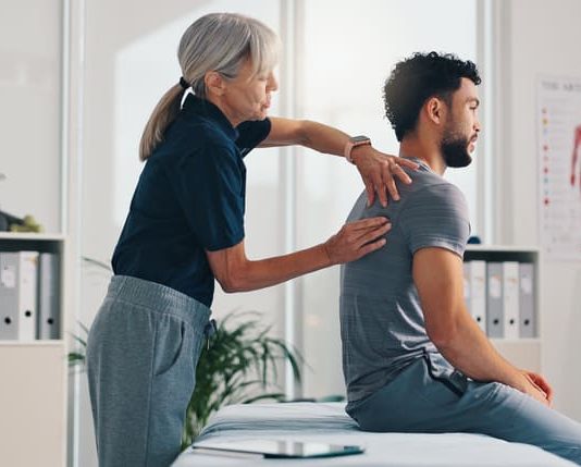 UK Musculoskeletal Crisis Costs NHS Billions: Custom Rehab Person, physical therapy on injury for rehabilitation or recovery of muscle damage in clinic. UK Musculoskeletal