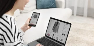 Woman with smartphone and laptop shopping online indoors or Multi-Platform Selling