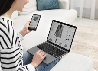 Woman with smartphone and laptop shopping online indoors or Multi-Platform Selling