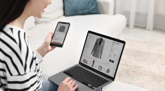 Woman with smartphone and laptop shopping online indoors or Multi-Platform Selling