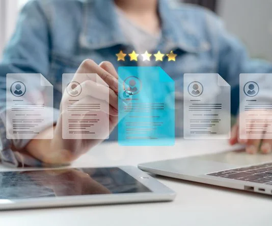 5 Best Europass Alternatives: AI Resume Builders for Switzerland in 2026 Human resource manager analyzing digital resumes with five-star rating system, selecting best candidate using AI technology and data-driven recruitment process.