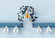 Fearless leader. Orange paper airplane breaking the wall barrier while others stuck, showing breakthrough, innovation, and leadership.