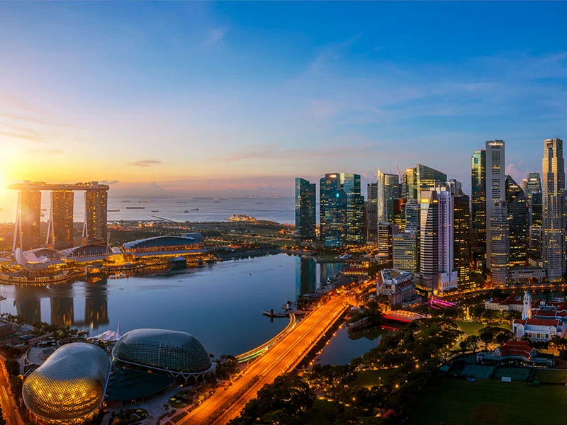 Singapore city and sunrise sky in harbour side view of hotel windows