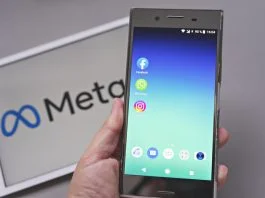 Can Meta Remain in the Big Tech Club? Mobile display with logo of Facebook, WhatsApp and Instagram apps in against blurred META logotype