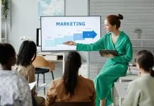 International Day of Marketing: Five Practical Skills CMOs Need Right Now Businesswoman giving new info about marketing. Learning practical Skills for CMO