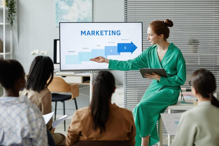 iStock-1408567753 (1) Businesswoman giving new info about marketing. Learning practical Skills for CMO