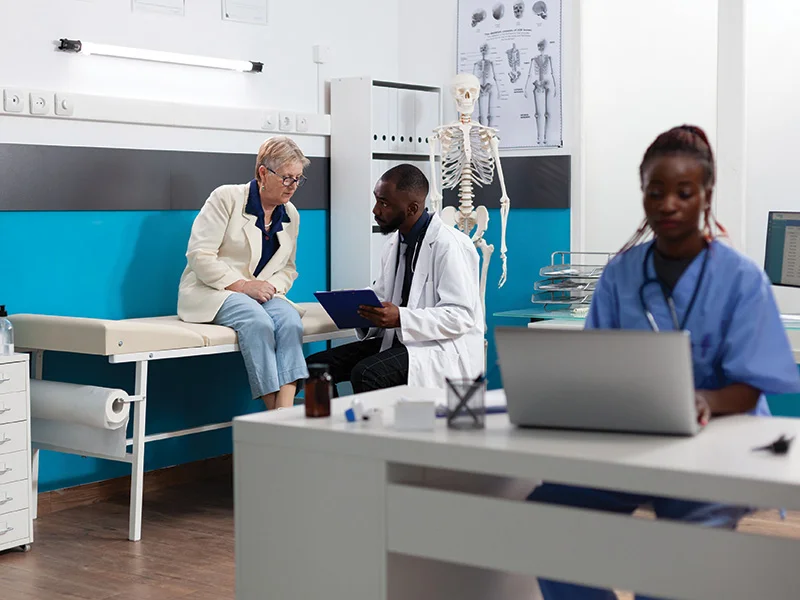 Specialist physician doctor discussing sickness symptoms with senior woman patient