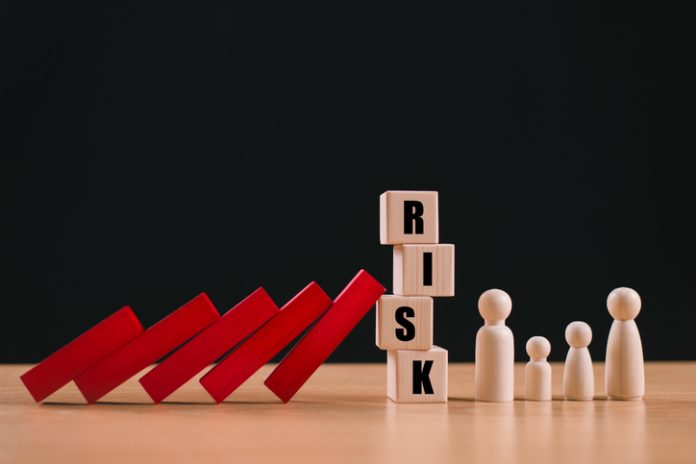 Risk assessment crisis concept. Financial analysis solution, real estate loan business management. Insurance technology plan protect home mortgage. House safety family life. Safe red wood domino block Geopolitical risks system