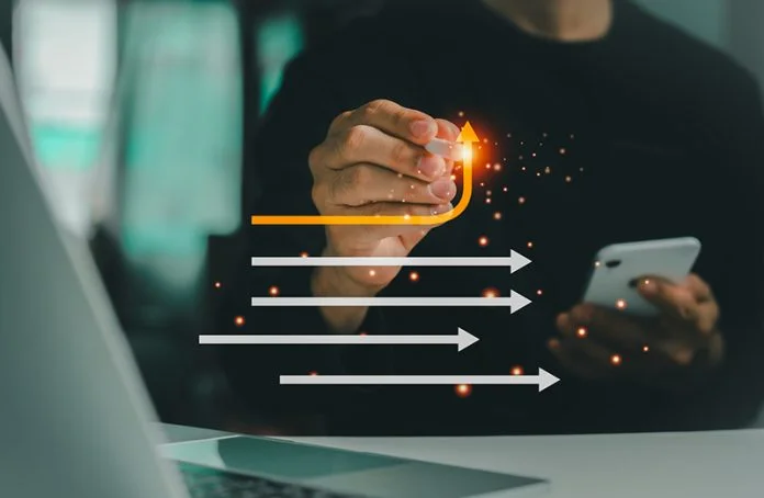 In this business management concept, a businessman erases a white arrow and draws a yellow arrow, symbolizing a strategic shift toward innovation and growth. radical renewal