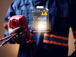 Why Electrical Safety Should Be a Business Priority electrical safety concept with electric staff holding multimeter to check power source before start working on machine system or construction site