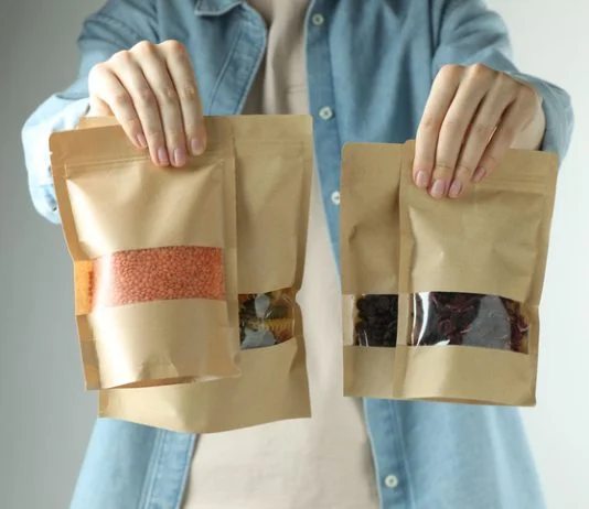 How Better Packaging Helps Brands Compete Without Price Cuts Woman with stand-up pouches of different products on light grey background
