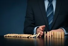 Businessman stop domino effect. Architecture is Failing You as a Leader concept
