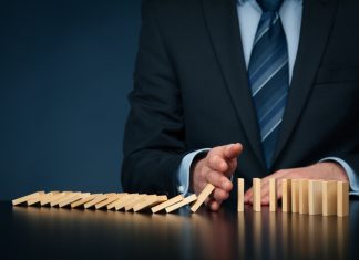 5 Signs Your Information Architecture is Failing You as a Leader Businessman stop domino effect. Architecture is Failing You as a Leader concept