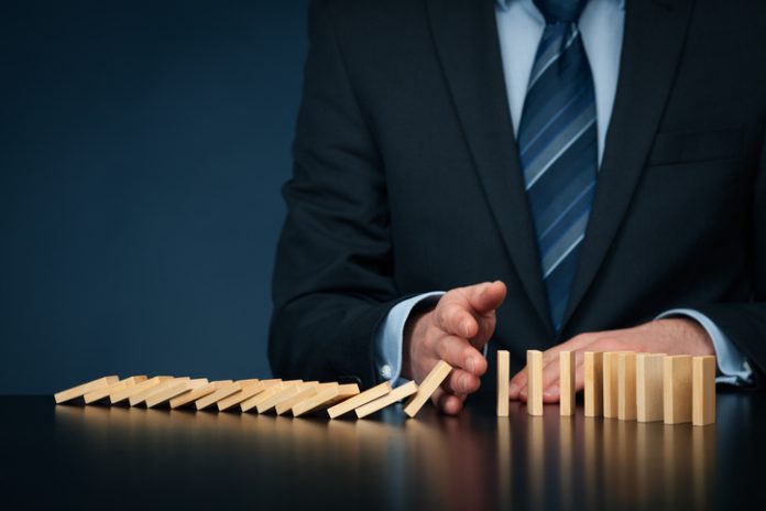 Businessman stop domino effect. Architecture is Failing You as a Leader concept