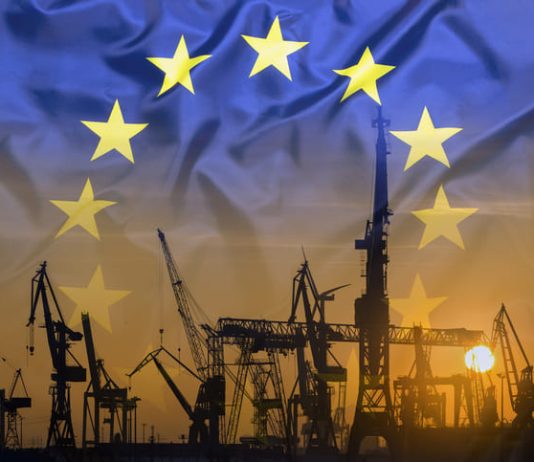 Industrial concept with European Union flag at sunset
