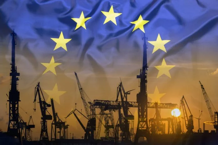 Industrial concept with European Union flag at sunset