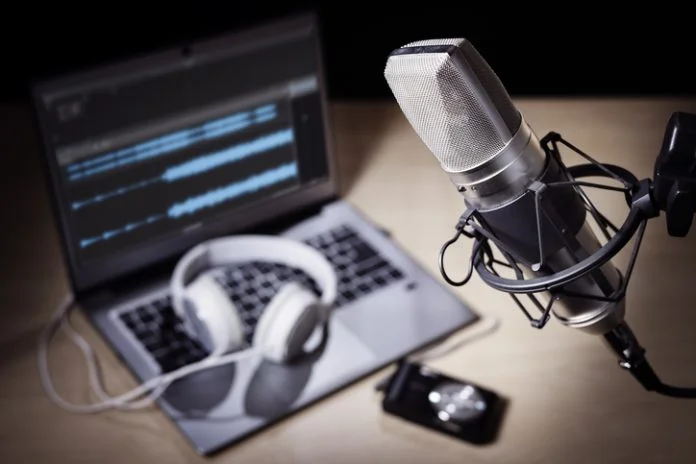 Podcast microphone and laptop computer in recording studio Music Businesses