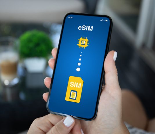 Woman hand hold phone with Sim card replacement on eSim