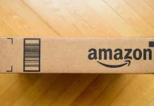 Amazon Business Featured Offer vs. Buy Box Strategies Amazon prime cardboard carton package on the wooden floor